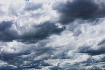 The dark sky with heavy clouds. Storm and rainy nature background. Bad or moody weather. Global warming, climate change.