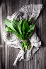 Bunch of fresh bear's wild garlic on wooden table close up. Food photography