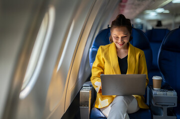 Young Businesswoman Working on Laptop in Flight