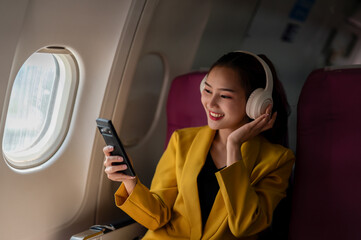 Woman Enjoying Music on Smartphone During Flight