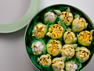 handmade dessert  yellow marshmallows in the form of flowers in a round box 