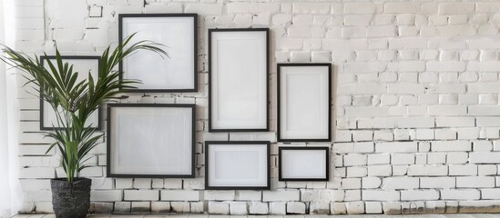 Collection of dark wooden frames on a white brick wall
