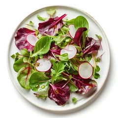 Fototapeten Simple vegetarian salad with green and purple mesclun mix and thin slices of radish, on a round ceramic plate. Light summer meal. Diet, healthy eating. White background. Top view. © Studio Light & Shade