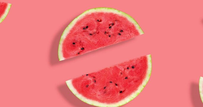 Video of flat lay of watermelon half slices on pink background. Watermelon summer video pattern. Summer fruit. Creative Minimal summer pop art concept