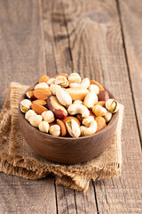 Healthy mix nuts on wooden background. Almonds, hazelnuts, cashews, peanuts, pistachios, Brazil nuts