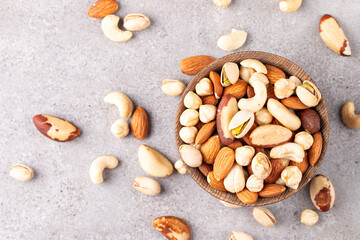 Fototapeta na wymiar Healthy mix nuts on wooden background. Almonds, hazelnuts, cashews, peanuts, pistachios, Brazil nuts
