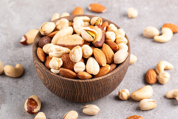 Healthy mix nuts on wooden background. Almonds, hazelnuts, cashews, peanuts, pistachios, Brazil nuts