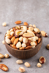 Healthy mix nuts on wooden background. Almonds, hazelnuts, cashews, peanuts, pistachios, Brazil nuts