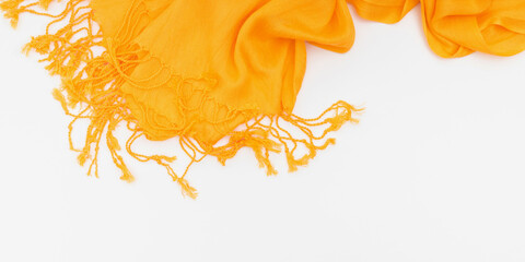 Autumn cozy composition. Yellow scarf on white background. Fall concept. Flat lay, top view, copy space