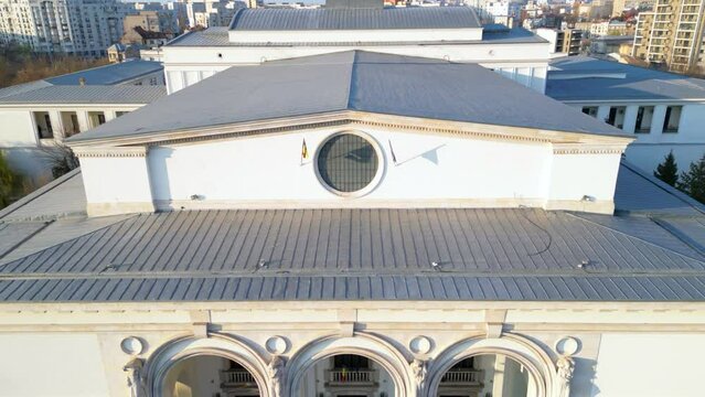 High angle aerial footage of the Bucharest National Opera House. Drone flyover shot of the building of the Johan Strauss Ensamble in the capital of Romania - Bucuresti. Sunny spring day shot.
