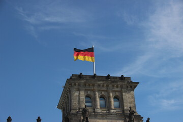 Germany flag waving in the wind on top of a building in Berlin