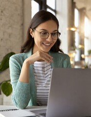 Happy young nice woman looking at the laptop screen, holding video call meeting conversation, discussing working issues, passing job interview from home. Distant communication concept