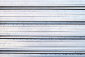 detail of metal door with orizontal lines, gray, in a house