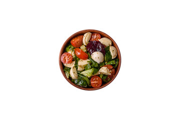 Delicious fresh caprese salad with mozzarella, tomatoes, greens with salt, spices and herbs - 767324849