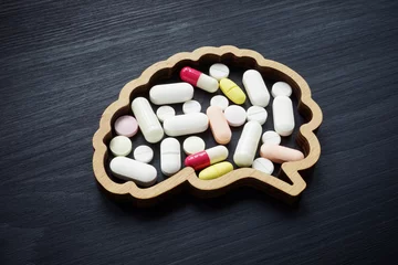 Fotobehang Brain full of pills. Dependence on drugs, medications for depression and mental illness. © Vitalii Vodolazskyi