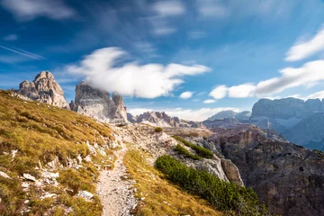 Draagtas Rocky footpaths below the monumental peak of Tre Cime with the cloudy blue sky © Simona_Mach