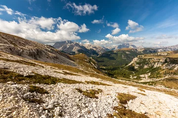 Wandcirkels plexiglas Rocky footpaths below the monumental peak of Tre Cime with the cloudy blue sky © Simona_Mach