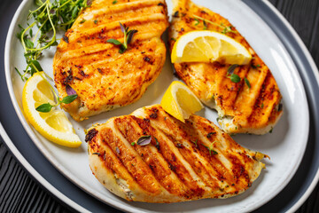 juicy grilled chicken cutlets on plate, top view