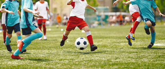 Young Players in Soccer Game. Boy Kicking Soccer Ball Towards Goal. School Boys Playing a Soccer...