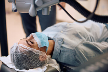 Young woman undergoing  laser eye surgery.