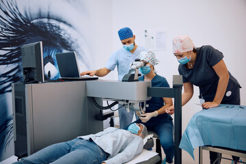 Female patient undergoing  laser eye surgery at ophthalmology clinic.