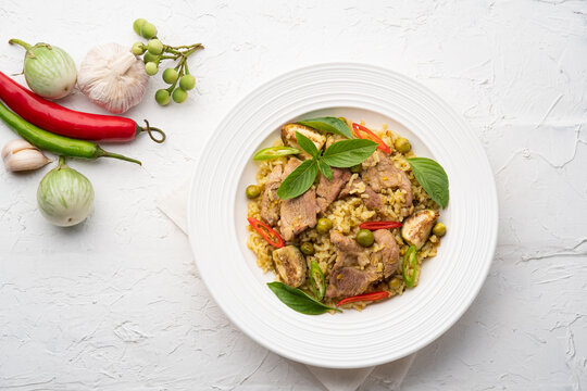 Green Curry Fried Rice with pork meat and basil in white plate.Top view