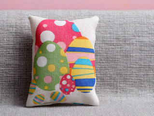 Easter cushion with colorful eggs on a sofa