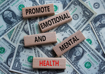 Health symbol. Wooden blocks with words Promote Emotional and Mental Health. Beautiful dollar...