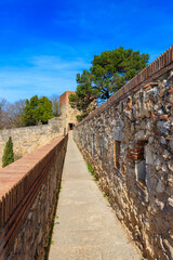Fototapeta premium Girona old city wall fortification, venerable 9th-century city walls with walkways, towers and scenic vantage points of city views of Girona, Catalonia, Spain