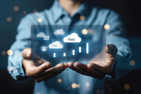 A man in business attire holds out his hands with a cloud. PaaS, Platform as a Service concept. Cloud computing service on software platform. Businessman holding cloud PaaS icon on virtual screen.