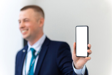 Handsome European Businessman Showing Smartphone With Blank White Screen At Camera.