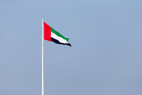 UAE flag waving in Abu Dhabi. UAE National day. UAE flag day.