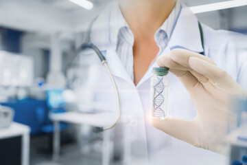 A lab technician shows a tube containing a DNA molecule.