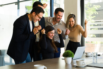 Team of businesspeople celebrating their success in a meeting room