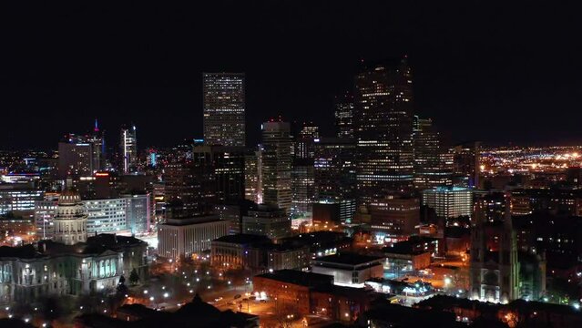 Aerial Forward Shot Of Illuminated Skyscrapers In Modern City Against Clear Sky At Night - Denver, Colorado