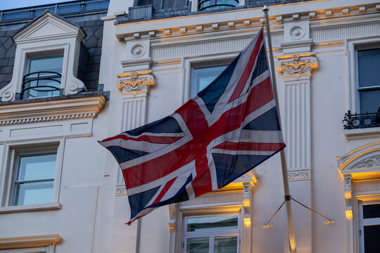 British flag flying on the balcony of a historic building in central London