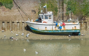 Petit bateau caboteur de pêche par marée basse à Saint-Valéry-en-Caux, Normandie, France