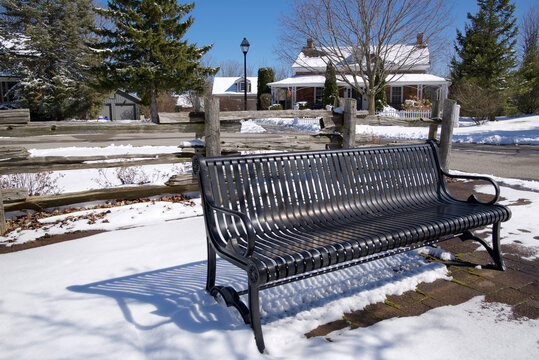 Winter landscape.  Empty park bench in the park of a small Canadian residential community
