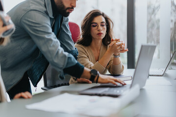 Successful multicultural team collaborating and strategizing in a creative office.