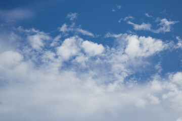 White cumulus clouds in the blue sky close-up