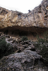 Naklejka premium Frontal view of Perico cave during a cloudy day of winter in Sierra del cid