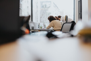 A diverse team of business coworkers collaborating and finding solutions in a modern co working...