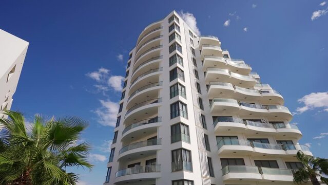 Modern beachfront condos with pool, lush palms, sea view for investment, real estate tour, lifestyle showcase.