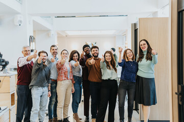 Multi generational businesspeople showing thumbs up and smiling as a successful corporate team.