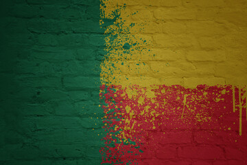 colorful painted big national flag of benin on a massive brick wall