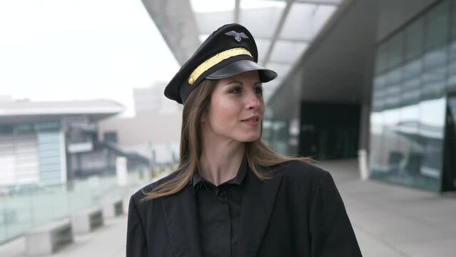Female Pilot Standing Confidently in front of an Airplane