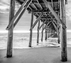 black and white photo of a fishing pier on topsail beach nc
