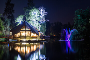 Night at Rybárska Bašta: Rajecke Teplice, Slovakia Spa park with lake illuminated by colourful lighting