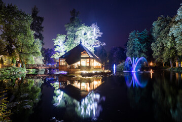 Night at Rybárska Bašta: Rajecke Teplice, Slovakia Spa park with lake illuminated by colourful lighting