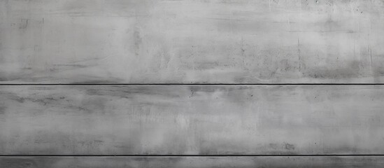 A close up of a rectangular grey concrete wall with wood tints and shades, creating a pattern of parallel lines. The symmetry and monochrome photography highlight the flooring texture